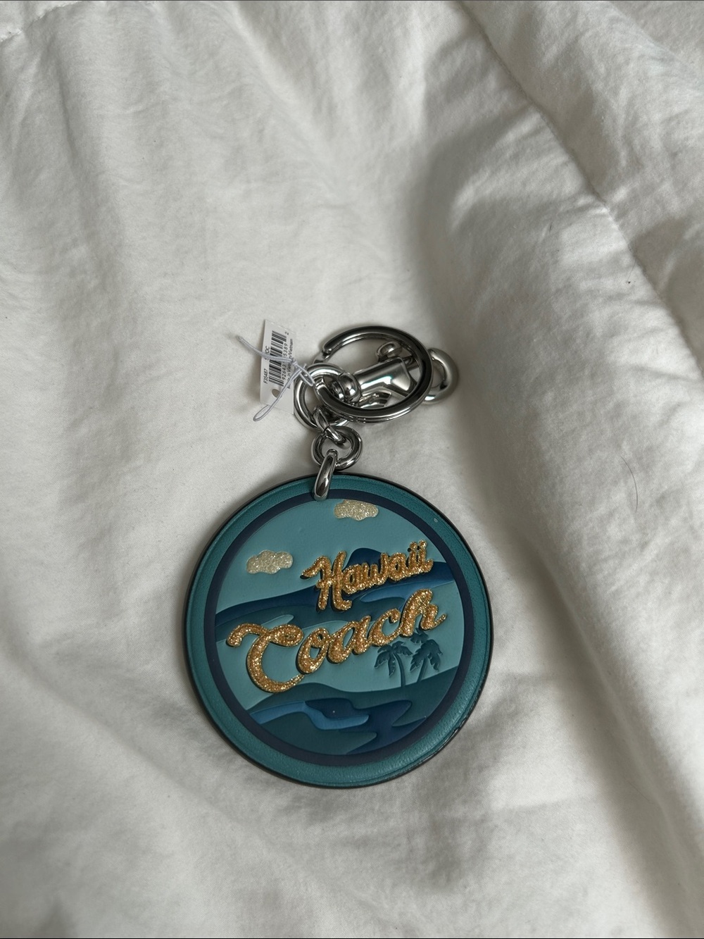 Coach Teal and Blue Hawaii Round Leather Keychain with Gold Script
Spot on back